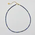 Detail of beaded necklace with blue natural stones and gold-plated heart charm - Necklace / 38+5cm / Lapis Blue