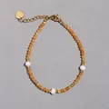 Dettaglio del bracciale con pietre naturali arancioni, perle d'acqua dolce e ciondolo a cuore - Stile Minerale Sfaccettato Arancione