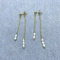 Detail of long gold chain tassel earrings featuring natural baroque white pearls on denim - Asymmetric Long Freshwater Pearl Tassel Earrings