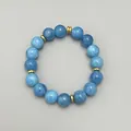 Makroaufnahme von 18k vergoldeten Zwischenperlen und natürlichen blauen Aquamarinsteinen - Armband / Blau
