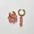 Golden asymmetrical hoop earrings featuring pink translucent beads and quartz style - Asymmetric Cluster And Vertical Design / Pink
