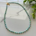 Detail of bohemian beaded necklace with turquoise stones and colorful beads on marble - Necklace / 38+5cm / Turquoise with Multicolor Beads