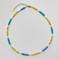 Close-up of multicolored stone beads with gold lobster clasp and heart tag detail - Necklace / 38+5cm / Blue Yellow Contrast