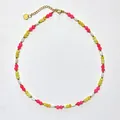 Detail view of handmade bohemian beaded necklace with golden heart pendant and lobster clasp - Necklace / 38+5cm / Pink & Yellow Contrast