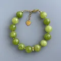 Dettaglio del bracciale con pietre verdi e ciondolo a cuore dorato con chiusura a moschettone - Bracciale / 17+3cm / Verde Prateria