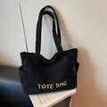 Borsa tote in velluto a coste nero con ricamo bianco e pratica tasca laterale - Nero