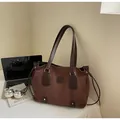 Brown faux suede tote bag shown with a laptop and book in a lifestyle office setting - Coffee