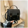 Vintage two-tone grey and black leather backpack with gold lettering and buckles - Black