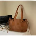 Dark brown minimalist tote bag in suede texture with long shoulder straps for daily commute - Brown