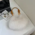Furry white plush moon bag with woven handle and decorative beads in minimalist setting - White