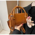Brown glossy handbag with top handles and a cute bear charm in retro British style - With Pendant / Yellow Brown