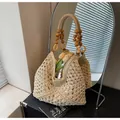 Handwoven straw tote bag with wood bead handles and intricate hollow crochet details - Off White