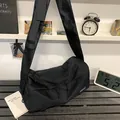 Large black minimalist waterproof nylon crossbody bag with wide shoulder strap - Black