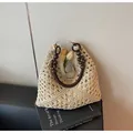 Beige woven straw tote bag with brown wooden bead handles and hollow geometric patterns - Black and Beige