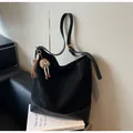 Detail of black suede hobo bag featuring leather patchwork and a cute bear charm - With Pendant / Black