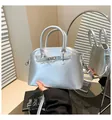 Chic silver metallic shell handbag with adjustable strap and decorative eyelet belt detail - One Size / Silver