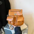 Brown vintage faux leather backpack with silver chain detail and dual front pockets - Brown