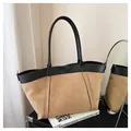 Detail of the large tote bag showing black lychee texture leather and khaki suede stitching - Khaki