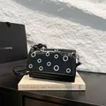 Chic black patent leather crossbody bag with silver eyelet studs on a modern square shape - One Size / Black