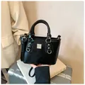 Chic black bucket bag with pebbled texture and silver hardware on a suitcase - With Pendant / Black