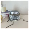 Silver pleated box bag with pearls and rhinestones on a minimalist desk setup - Pink