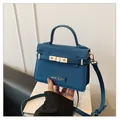 Detail of navy blue crossbody bag showing crossgrain leather and gold brand logo - One Size / Dark Blue