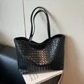 Classic black hand-woven tote bag with dual shoulder straps and Intrecciato texture - Black