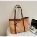 Light brown woven straw tote bag with dark leather straps and heart charm detail - With Pendant / Khaki