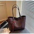 Dark brown large woven tote bag with artistic charm pendant and slim shoulder straps - With Pendant / Coffee