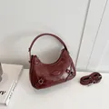 Minimalist wine red crescent handbag in glossy patent leather with silver hardware accents - Burgundy