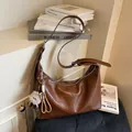 Brown leather large tote bag with wide strap and plush pendant on a white background - With Pendant / Brown