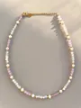 Detailed shot of handmade necklace with natural gems, pearls and 18k gold lobster clasp - Light Purple Milky White Style (1)