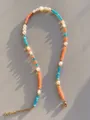 Macro detail of handmade necklace with colorful beads, pearls and 18k gold lobster clasp - Orange Blue Faceted Style (23)