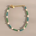 Macro detail of natural stone beaded bracelet with gold chain and freshwater pearl - Blue Green Cut Beads with Irregular Pearl