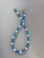 Close-up of beaded necklace with blue rectangle stones, pearls, and gold extender chain - Blue Geometric Style (24)