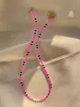 Detail of colorful beads and white pearls on a gold-plated necklace on satin fabric - Fluorescent Pink Black White Style (32)