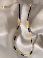 Detail of natural gemstone beaded necklace with pearls and gold adjustable chain - Black Yellow White Patchwork Style (13)