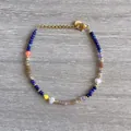 Detailed view of colorful natural stone beads and pearls on an 18K gold plated bracelet - Colorful Cut Beads with Pearl