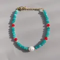 Detail of 18K gold-plated beaded bracelet with blue stone beads and a natural pearl - Cyan Cut Beads with Red Beads and Pearl
