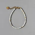 Detail van de natuurstenen kralenarmband met 18k gouden hartvormige hanger en sluiting - Meerkleurig