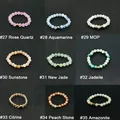Detailed grid of nine natural stone beaded elastic rings with central gold accent bead - 6cm / Aquamarine (#28)