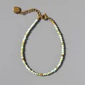 Detail of natural stone beaded bracelet with 18k gold heart charm and extension chain - Amazonite Color