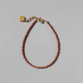 Detail of beaded gemstone bracelet with heart charm and 18k gold plated clasp - Orange Red