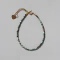 Detail of beaded bracelet with green natural stones and a gold heart pendant charm - Cyan Brown Mix