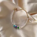 Dettaglio di bracciale con perle, ciondolo malocchio e chiusura dorata regolabile - Stile Perline Colorate Malocchio (25SL1-11) / 17+3cm