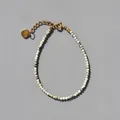 Detailed view of natural stone beaded bracelet with 18k gold heart charm and lobster clasp - Moss Green