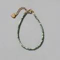 Detail of beaded natural stone bracelet with 18k gold plated heart charm and extension chain - Emerald Marble