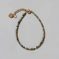 Detail of beaded natural stone bracelet with 18k gold plated heart charm and clasp - Khaki