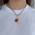 Collier chaîne doré avec cœur rouge, poisson et perle sur t-shirt blanc - Collier Chaîne Fer à Cheval Or Coeur Poisson