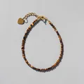 Detail of faceted tiger eye beaded bracelet with 18k gold heart charm and chain - Tiger Eye